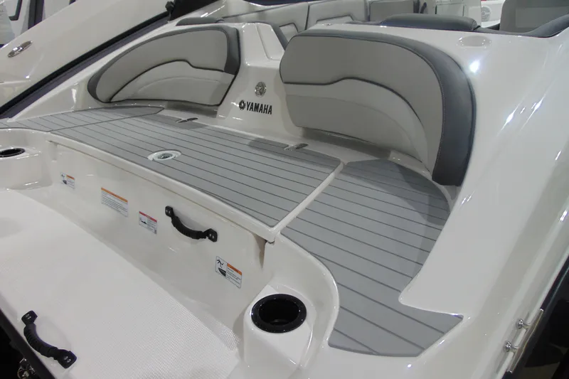 Slide: The Image of 2025 Yamaha AR190 boat interior with gray seating and deck, showcasing modern design. - 14