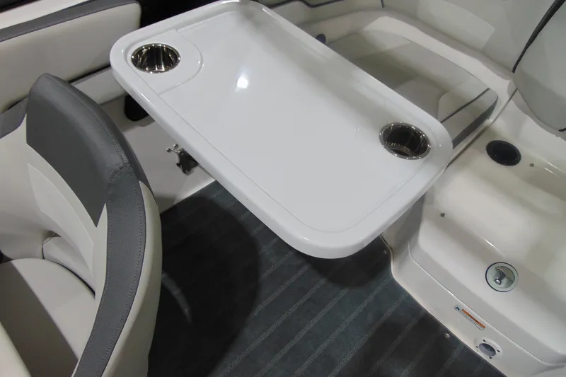 Slide: The Image of 2025 Yamaha Boats AR190 interior with table and cup holders. - 23