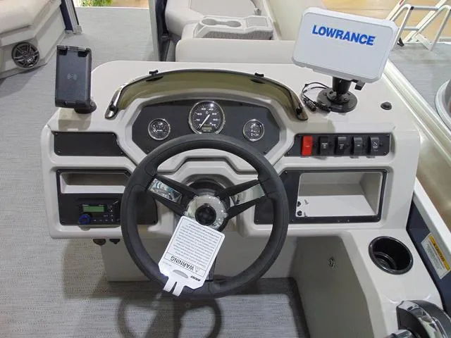 Slide: The Image of 2025 Godfrey Pontoons Sweetwater 2286 SFL dashboard with steering wheel and Lowrance navigation system. - 12