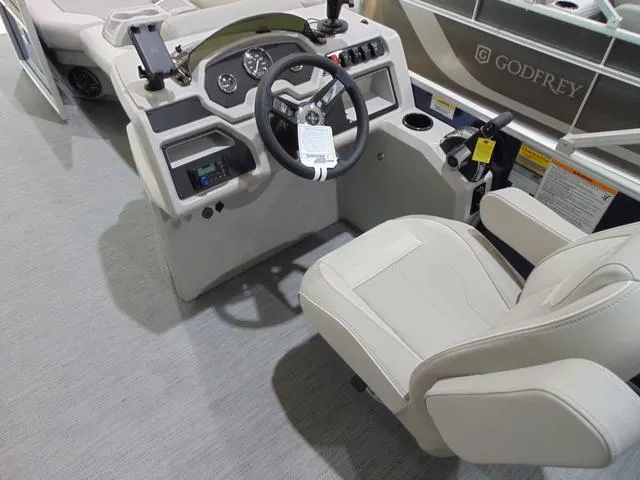 Slide: The Image of Captain's helm of 2025 Godfrey Sweetwater 2286 SFL pontoon boat, featuring modern controls and seating. - 6