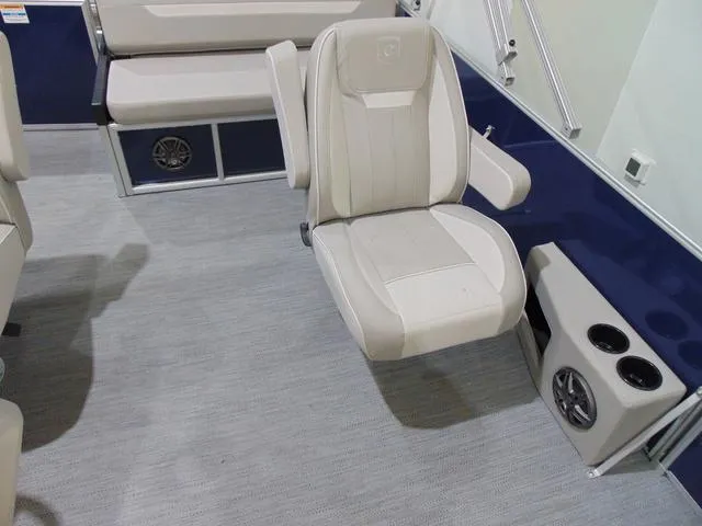 Slide: The Image of 2025 Godfrey Pontoons Sweetwater 2286 SFL interior with beige seating and cup holders. - 8