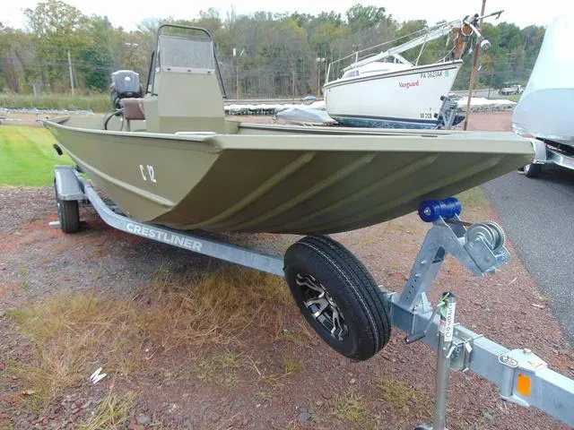 Slide: The Image of 2024 Crestliner 2070 Retriever CC boat on trailer, parked outdoors. - 11