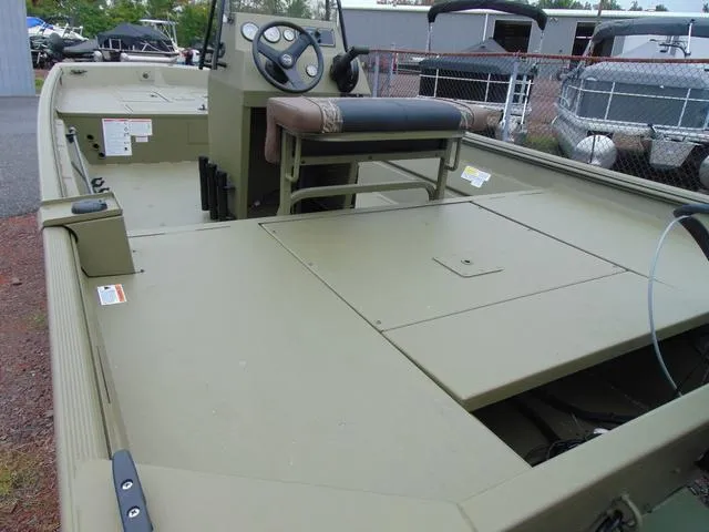 Slide: The Image of 2024 Crestliner 2070 Retriever CC boat with center console and seating, parked outdoors. - 5