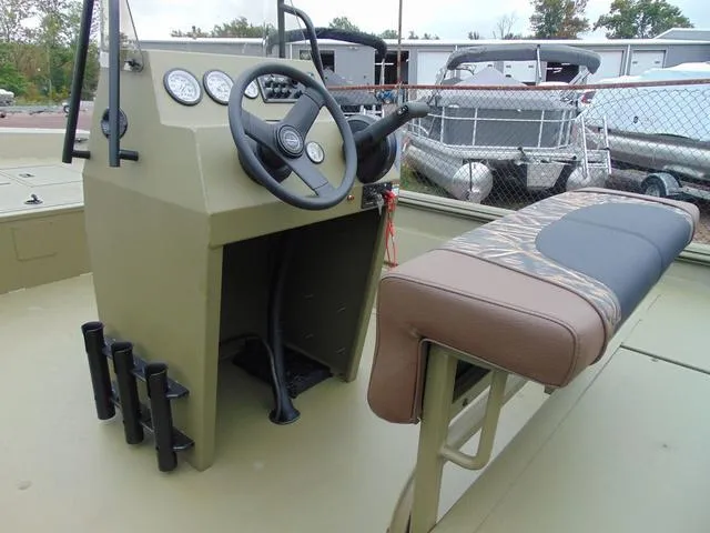 Slide: The Image of 2024 Crestliner 2070 Retriever CC boat interior with steering console and cushioned seating. - 6