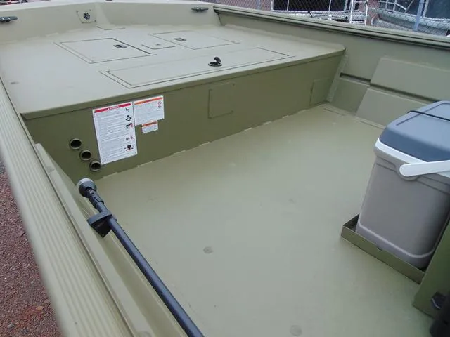 Slide: The Image of 2024 Crestliner 2070 Retriever CC boat interior with storage compartments and cooler. - 7