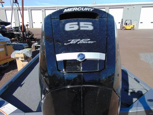 Slide: The Image of 2025 Crestliner 1700 Ridge with Mercury 65 Jet Power engine in outdoor setting. - 2