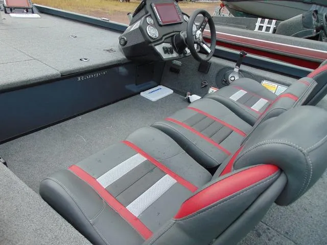 Slide: The Image of 2023 Ranger RT188C boat interior with gray and red seats, steering wheel, and dashboard. - 4