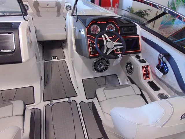 Slide: The Image of 2024 Hurricane SunDeck 2600 OB boat interior with modern dashboard and seating. - 10