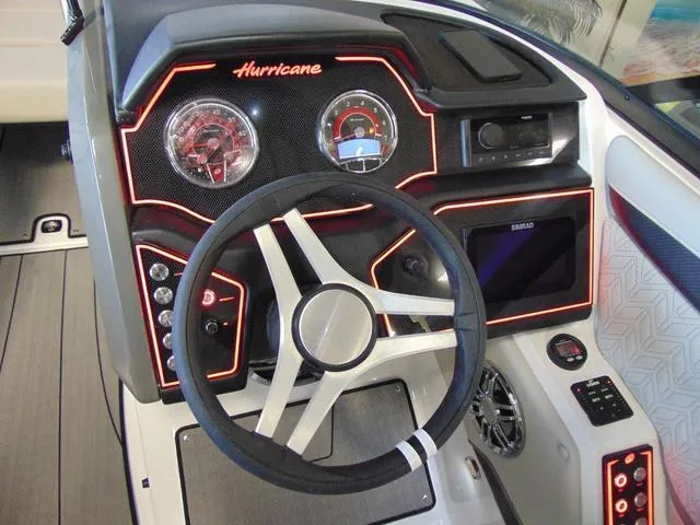 Slide: The Image of 2024 Hurricane SunDeck 2600 OB dashboard with illuminated controls and modern steering wheel. - 11