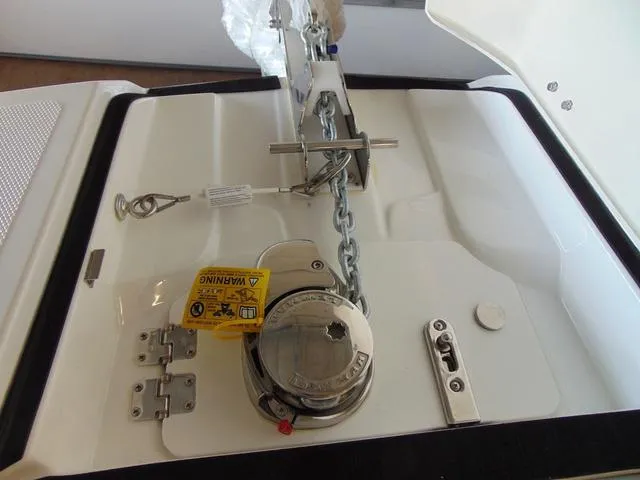 Slide: The Image of 2024 Hurricane SunDeck 2600 OB anchor system with chain and winch mechanism. - 14