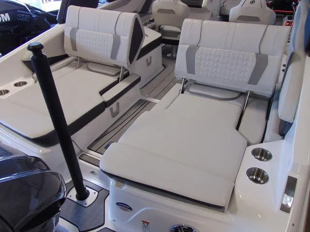 Slide: The Image of 2024 Hurricane SunDeck 2600 OB boat interior with comfortable seating and cup holders. - 4