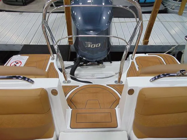 Slide: The Image of 2025 Hurricane SunDeck 2486 OB boat with Yamaha 300 engine, featuring tan seating and deck. - 10