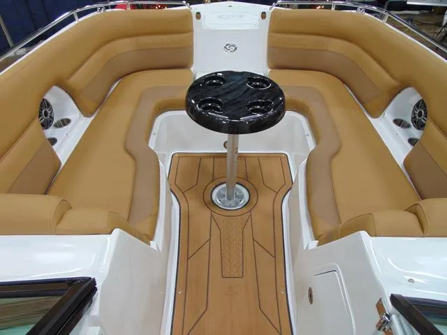 Slide: The Image of 2025 Hurricane SunDeck 2486 OB boat interior with tan seating and central table. - 8