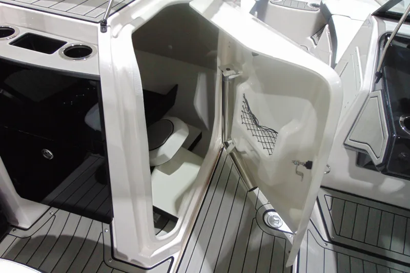 Slide: The Image of 2025 Yamaha Boats 252S interior cabin with open door, showcasing seating and storage. - 12