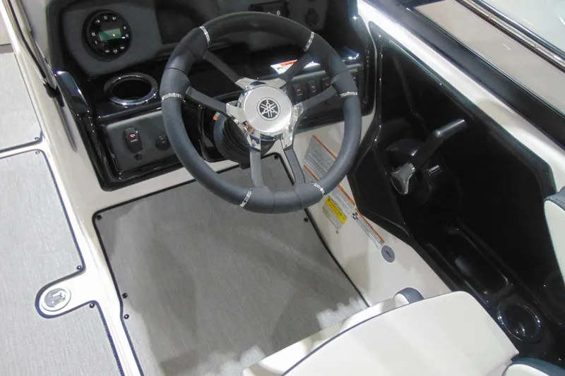 Slide: The Image of 2025 Yamaha AR195 boat cockpit with steering wheel and controls. - 12