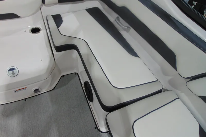 Slide: The Image of 2025 Yamaha AR195 boat interior seating with sleek white and black design. - 16