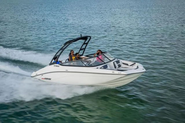 Slide: The Image of 2025 Yamaha AR195 boat cruising on open water with passengers enjoying the ride. - 7