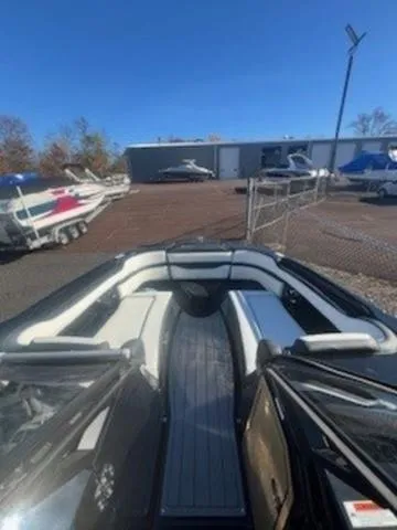 Slide: The Image of 2025 Yamaha Boats 275SD with sleek interior design, docked outdoors. - 10