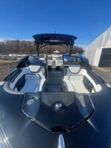 Slide: The Image of 2025 Yamaha Boats 275SD, sleek black design, spacious seating, outdoor display. - 4