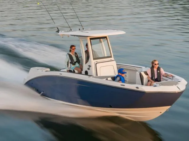 Slide: The Image of 2025 Yamaha Boats 252 FSH Sport cruising on water with passengers enjoying the ride. - 2