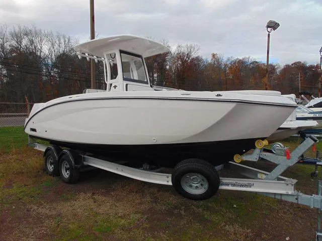 Slide: The Image of 2022 Yamaha Boats 252 FSH® SPORT on trailer, side view, outdoors. - 1