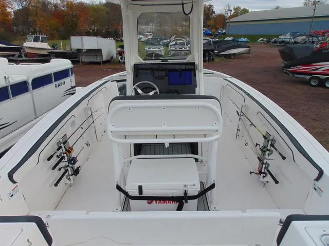 Slide: The Image of 2022 Yamaha Boats 252 FSH® SPORT, center console, fishing rods, outdoor setting. - 4