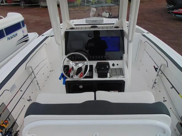 Slide: The Image of 2022 Yamaha Boats 252 FSH® SPORT dashboard with steering wheel and control panel. - 5