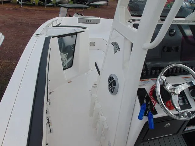 Slide: The Image of 2022 Yamaha Boats 252 FSH® SPORT interior, featuring helm controls and seating area. - 6