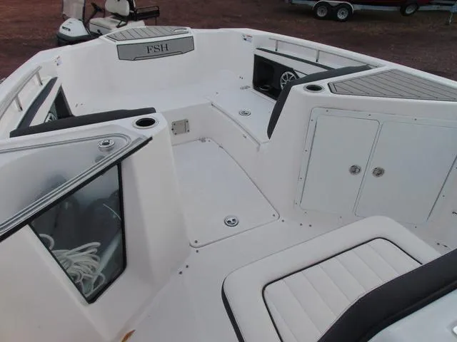 Slide: The Image of 2022 Yamaha Boats 252 FSH® SPORT interior, featuring spacious seating and storage compartments. - 8