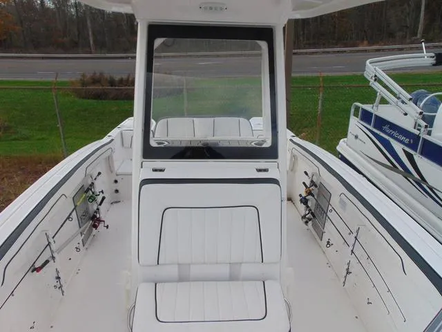 Slide: The Image of 2022 Yamaha Boats 252 FSH® SPORT interior with seating and fishing rod holders. - 9