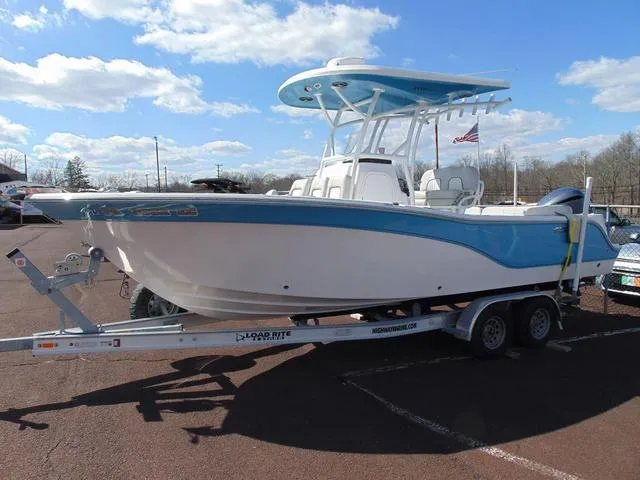 The Image of 2022 Sea Fox 249 Avenger boat on trailer under blue sky. - 1
