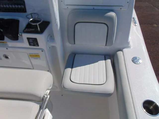 Slide: The Image of 2022 Sea Fox 249 Avenger boat interior with white cushioned seating and control panel. - 15