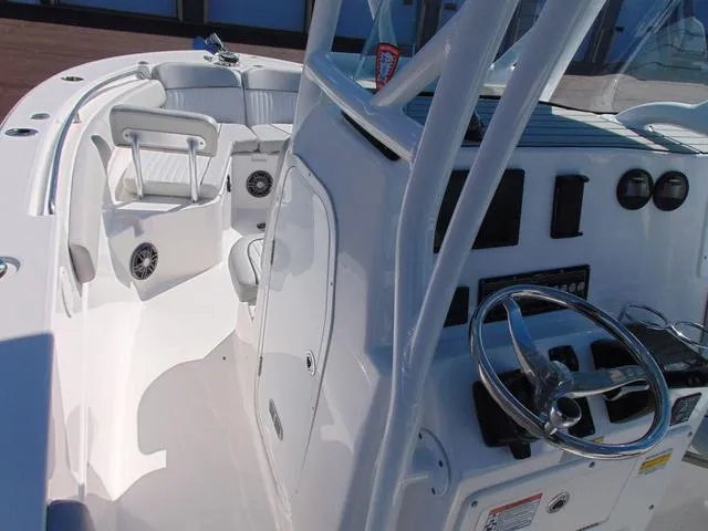 Slide: The Image of 2022 Sea Fox 249 Avenger boat interior with steering wheel and seating area. - 16
