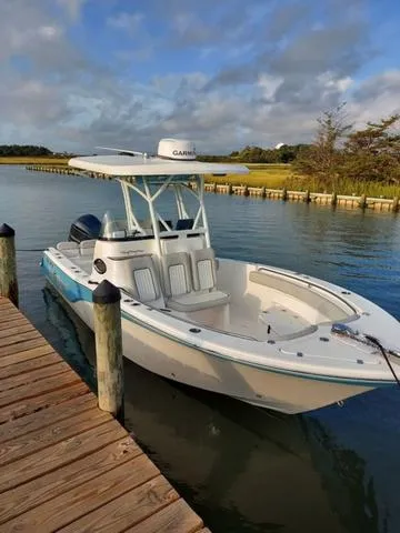 Slide: The Image of 2022 Sea Fox 249 Avenger boat docked on a calm waterway. - 22
