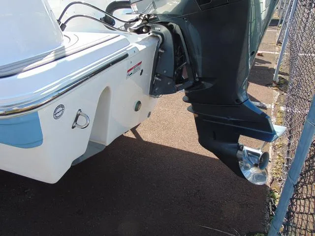 Slide: The Image of 2022 Sea Fox 249 Avenger boat stern with outboard motor, docked on pavement. - 7