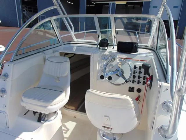 Slide: The Image of 2011 Sea Chaser 2100 Walk-Around boat interior with steering wheel and seating. - 10