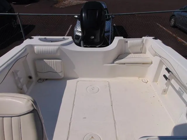 Slide: The Image of 2011 Sea Chaser 2100 Walk-Around boat interior with seating and motor. - 14