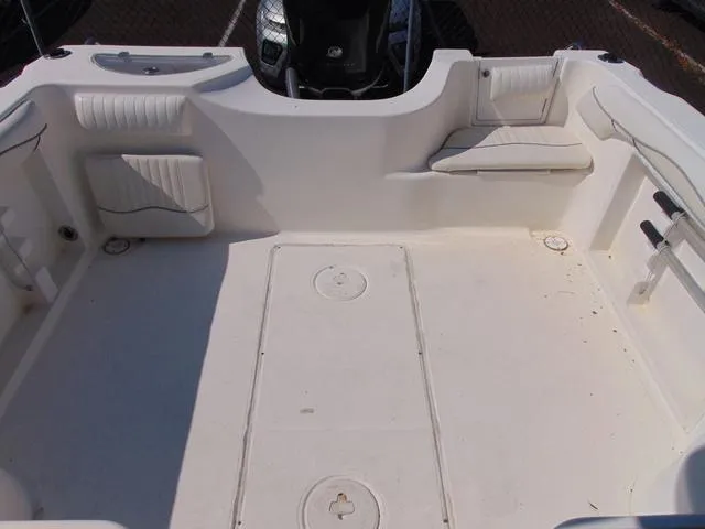 Slide: The Image of 2011 Sea Chaser 2100 Walk-Around boat interior with seating and storage compartments. - 15