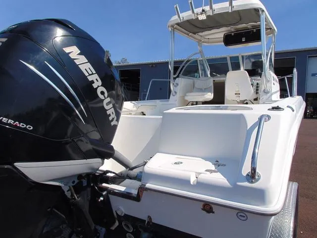 Slide: The Image of 2011 Sea Chaser 2100 Walk-Around boat with Mercury outboard engine, docked outdoors. - 6