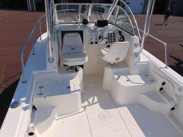 Slide: The Image of 2011 Sea Chaser 2100 Walk-Around boat interior with helm and seating. - 8