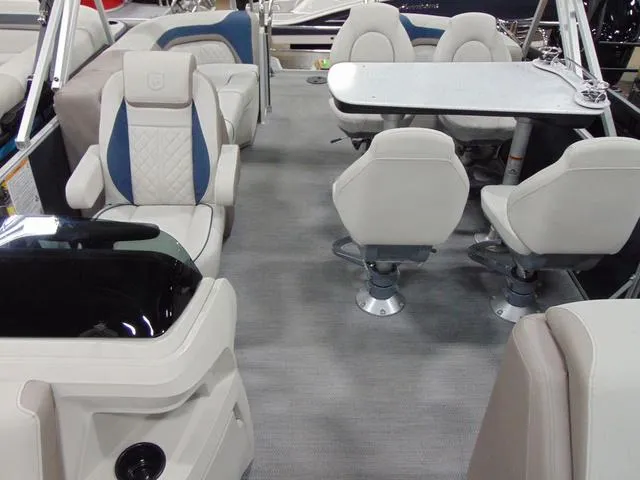 Slide: The Image of 2025 Godfrey Pontoons Sweetwater 2286 MT interior with table and swivel chairs. - 4