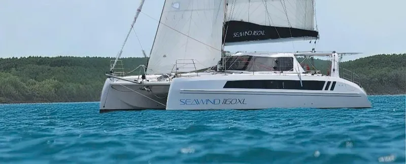 The Image of 2025 Seawind 1160 XL catamaran sailing on blue ocean waters. - 0