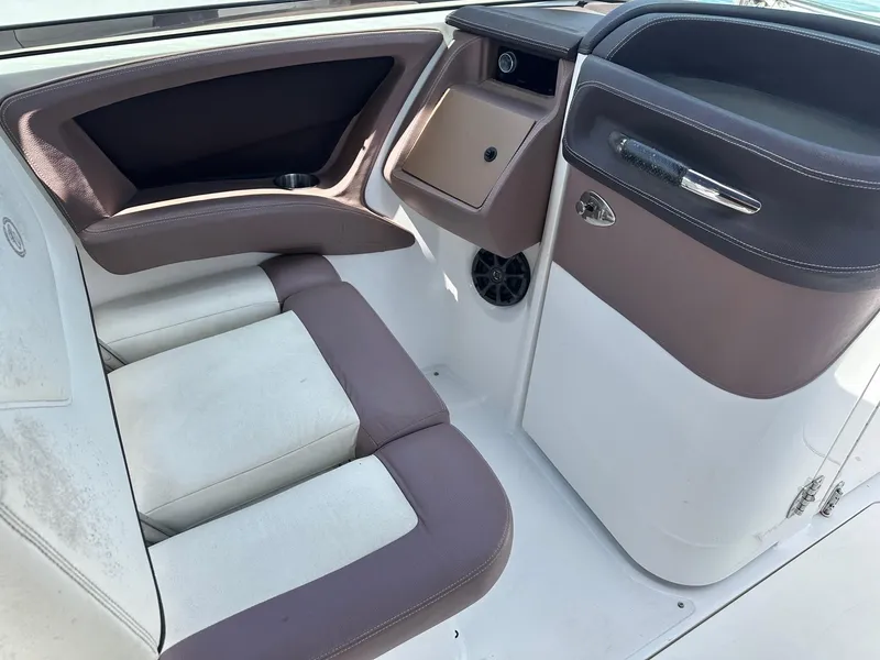 Slide: The Image of Interior of a 2012 Cobalt 302 boat, featuring brown and white seating. - 10