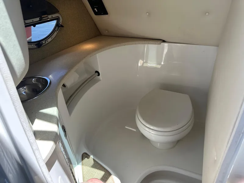 Slide: The Image of 2012 Cobalt 302 boat interior bathroom with toilet and sink. - 11