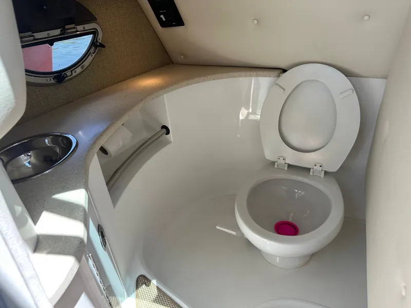 Slide: The Image of Interior of a 2012 Cobalt 302 boat bathroom with toilet and sink. - 12