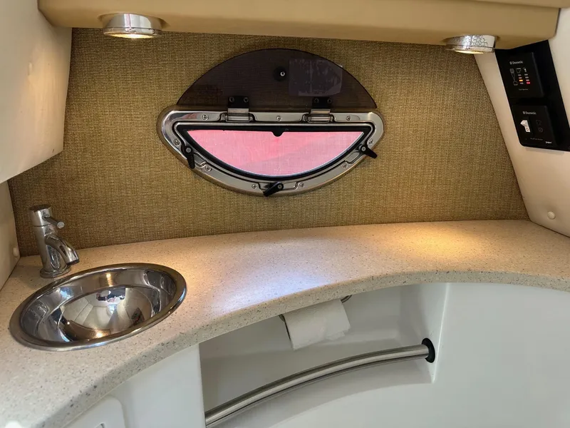 Slide: The Image of 2012 Cobalt 302 boat interior with sink, countertop, and porthole window. - 13
