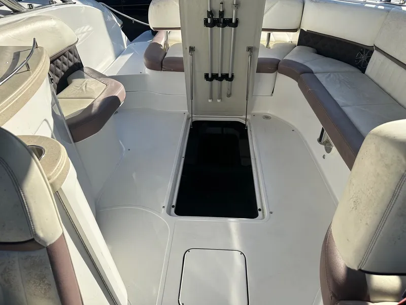 Slide: The Image of Interior of a 2012 Cobalt 302 boat with white and beige seating. - 19