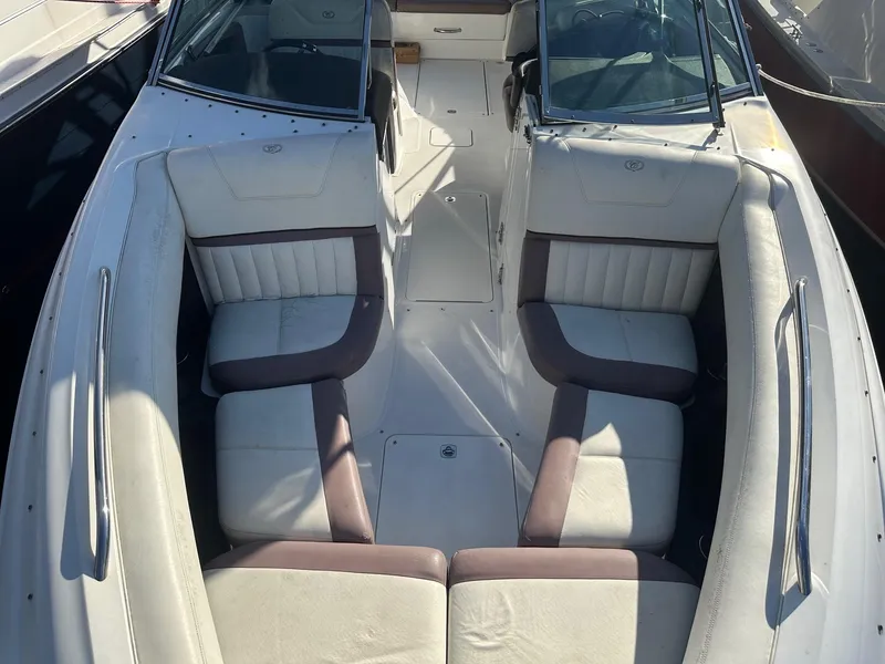 Slide: The Image of 2012 Cobalt 302 boat interior with white and brown seating, viewed from above. - 22