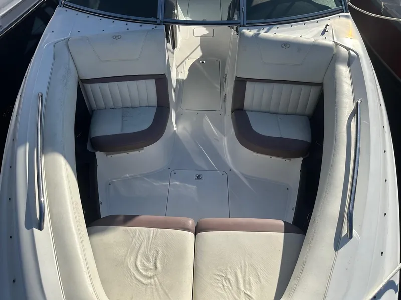 Slide: The Image of 2012 Cobalt 302 boat interior with white and brown seating. - 24