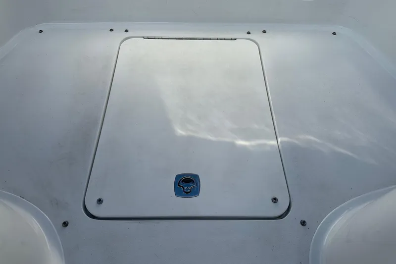 Slide: The Image of 2012 Cobalt 302 boat deck with storage hatch, featuring a sleek white finish. - 27